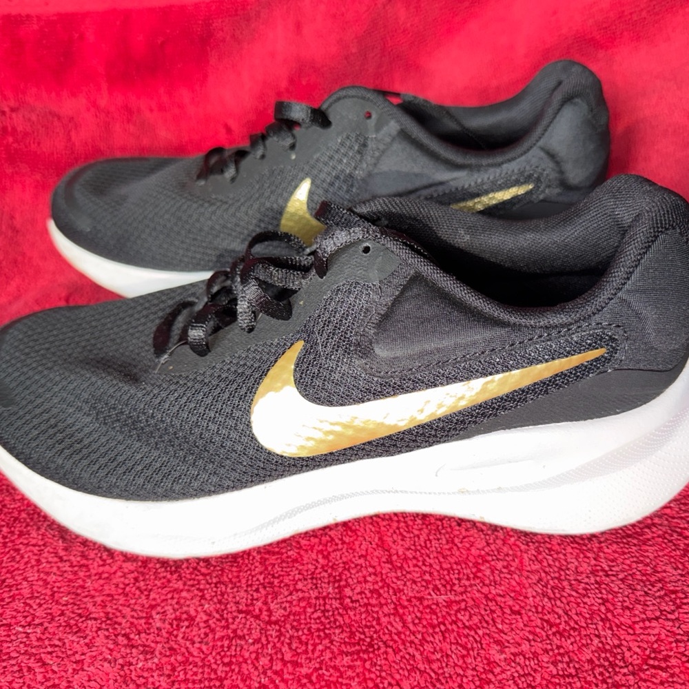 Nike black and with gold logo sneakers size 8.5 wide
